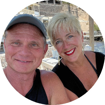 Two people standing together with a scenic background
